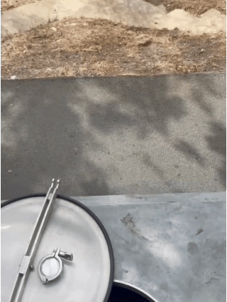 A punchdown in a concrete tank and a pumpover of a red fermentation.